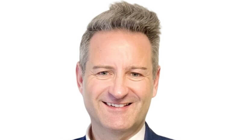 An image of a man smiling into the camera.